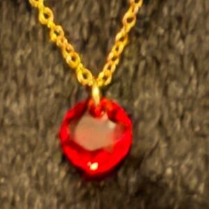 New Lab Created Ruby stone .50 carat with 14k gold plated chain.